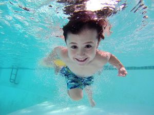 Kind taucht unter Wasser